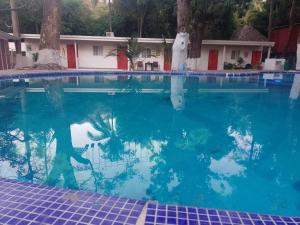 a woman standing in the water in a swimming pool at Sunzal Refugio Perfecto-3 in El Sunzal