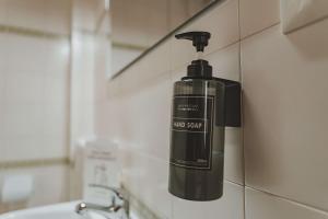 a soap dispenser on a wall next to a sink at Casa Arcadia Centro de Andalucía in Encinas Reales +27 photos