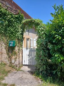 an entrance to a house with a white gate at La Source de Romay 2 pers 5 min Paray in Volesvres