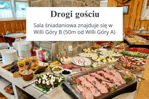 a buffet of meats and vegetables on a table at Willa Góry A - Noclegi z widokiem na góry śniadaniami i sauna in Bukowina Tatrzańska