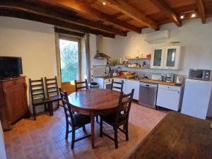 a kitchen with a table and chairs in a room at La Source de Romay 2 pers 5 min Paray in Volesvres
