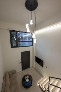 a living room with a couch and a table at NOMA Suites in Kalamata