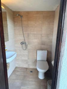 a bathroom with a toilet and a sink and a shower at Fisherman's Cove Epanomi in Epanomi