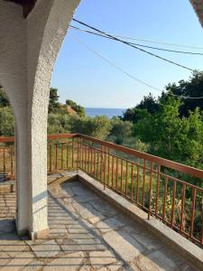 a balcony with a wooden railing and a view of the ocean at Fisherman's Cove Epanomi in Epanomi