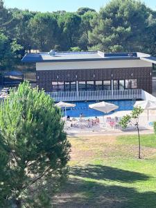 a building with a swimming pool with umbrellas at Agapanthe in Remoulins