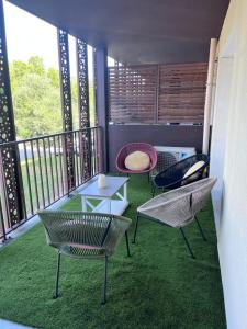 a balcony with two chairs and a table on a balcony at Agapanthe in Remoulins