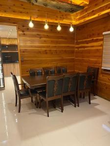 a wooden dining room with a table and chairs at Casa Costanera in Panguipulli