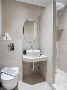 a bathroom with a sink and a toilet and a mirror at Studio Lia in Skala Marion