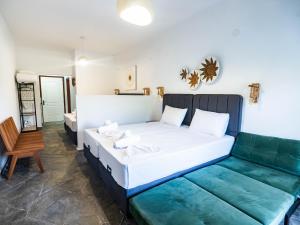 a room with a bed and a couch in it at Studio Lia in Skala Marion