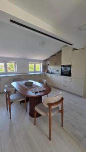 a kitchen with a table and chairs in a room at Square View Apartment Center Niksic in Nikšić