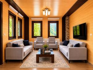 a living room with two couches and a coffee table at Şimo Suite Otel in Uzungöl