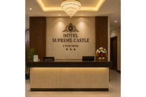 a hotel reception counter with a sign that reads hotel supreme castle at Hotel Supreme Castle - Okhla Bird Sanctuary in Noida