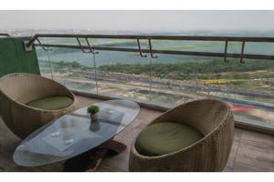 a table and chairs with a view of a highway at Hotel Supreme Castle - Okhla Bird Sanctuary in Noida