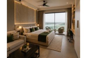 a bedroom with a bed and a couch and a window at Hotel Supreme Castle - Okhla Bird Sanctuary in Noida +19 photos