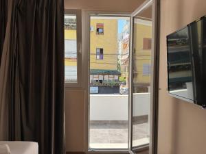 a sliding glass door with a view of a building at Hotel Djakbe in Tirana +42 photos
