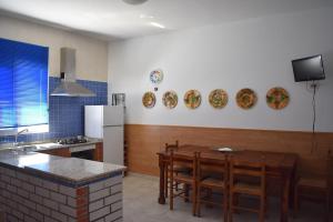 a kitchen with a table and some plates on the wall at Casa Nicolás in Portomarin