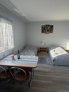 a room with a bed and a table and chairs at W zieleni in Polanica-Zdrój +64 photos