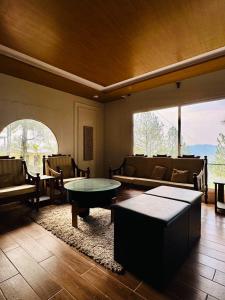 a living room with couches and a table at The Margallia in Islamabad +9 photos