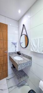 a bathroom with a sink and a mirror at Águas de Canto Grande in Bombinhas +88 photos
