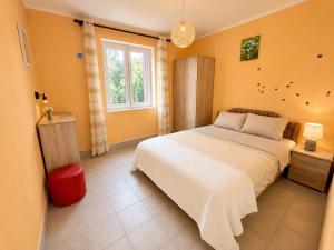a bedroom with a white bed and a window at CERES APARTMENTS free parking, kitchen & wi-fi in Utjeha