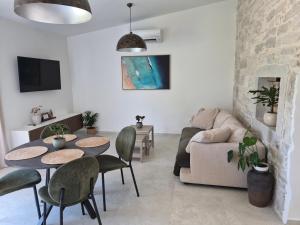 a living room with a table and chairs and a couch at Mareya Premium Stay in Poreč