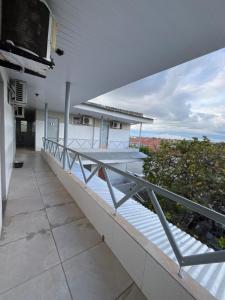 an outdoor balcony with a view of the ocean at Pousada do Gil in Iguatu