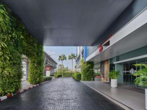 an empty street in a building with plants at ibis Bangkok IMPACT in Nonthaburi +90 photos