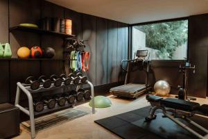 a room with a gym with a lot of weights at Arx Boutiquehotel in Schladming