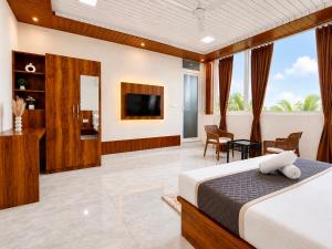 a hotel room with a bed and a television at SS Luxury Comforts - Twin Sharing in Chikmagalūr