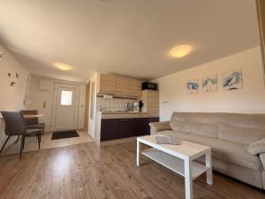 a living room with a couch and a table at Ferienwohnung 3 & 4 Wald & See in Zirchow