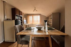 a kitchen and dining room with a wooden table at Mountain View Apartment in Troyan