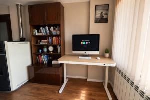 a computer sitting on a desk in a room at Mountain View Apartment in Troyan