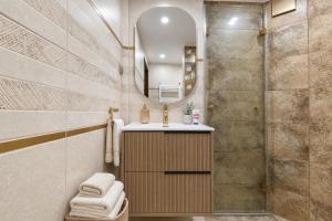 a bathroom with a shower and a sink and a mirror at Mountain View Apartment in Troyan +21 photos