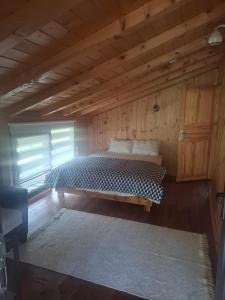 a bedroom with a bed in a wooden room at Altın Vadi Konaklama in Fındıklı
