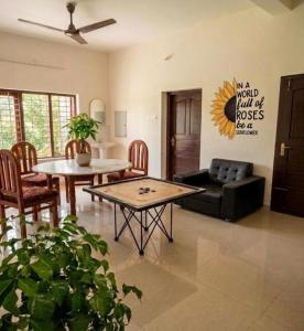 a living room with a couch and a table at Villa mud apples varkala in Varkala
