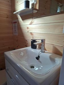 a bathroom with a white sink and a mirror at Sielska Przystań in Gąski +40 photos