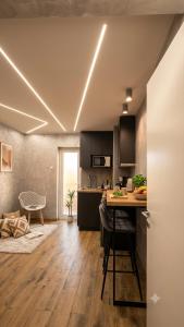 a kitchen with black cabinets and a table with chairs at Wonderland spa free parking in Niš