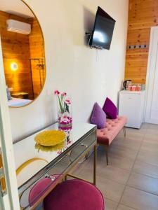 a room with a mirror and a table and a couch at Divine Studios A1 in Elafonisos +4 photos