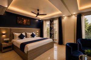 a bedroom with a bed and a ceiling fan at Hotel Vibe BLU & Banquet Near Advant, Embassy Oxygen & Sector 142,143 Metro, Noida in Noida