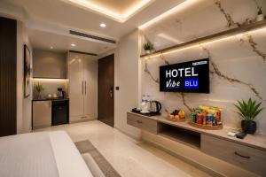 a hotel like room with a sign on the wall at Hotel Vibe BLU & Banquet Near Advant, Embassy Oxygen & Sector 142,143 Metro, Noida in Noida +33 photos