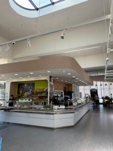 a food court with a counter in a building at Hotel PM Palace in Nizhnyaya Alekseyevka