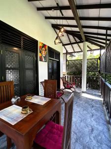 a wooden table and chairs in a room at Sunbeam Villa in Tangalle