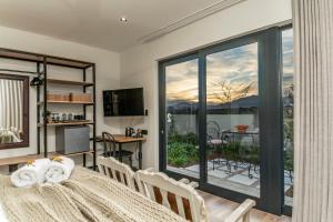 a dining room with a table and a large window at Fifty Ridge in George
