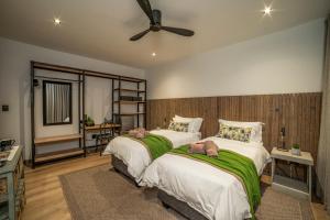 a bedroom with two beds and a ceiling fan at Fifty Ridge in George