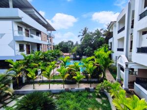 an apartment complex with a courtyard with palm trees at Studio by Jackfruit in Arambol