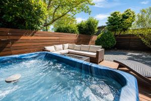 a swimming pool with a couch and a chair at Seaside Saloon Hot Tub Getaway in Sequim
