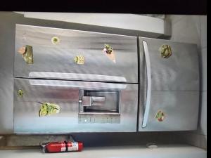 a stainless steel refrigerator in a kitchen with a can opener at BW Hideaway in Portmore