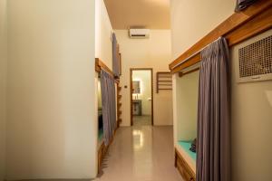 a hallway leading to a room with a fish tank at The Purple Pineapple Beach Hostel in Kuta Lombok