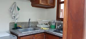 a kitchen with a sink and a counter top at Casa Leo in Villa de Leyva