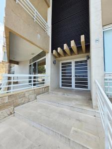 a house with a staircase on the side of it at New Halat, Linda in Jbeil